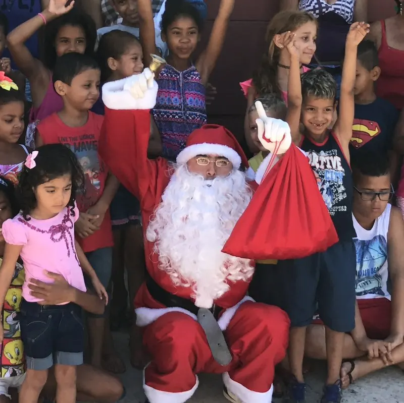 Papai Noel com crianças em ação social de Natal do Doe Dance